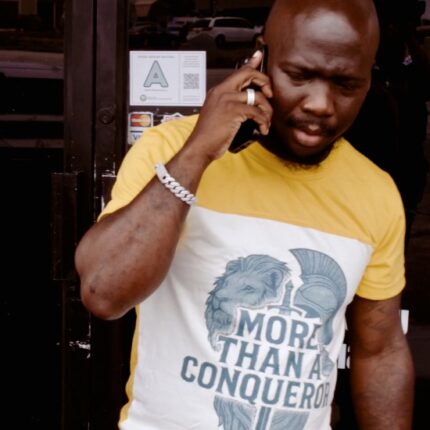 Man wearing More Than A Conqueror T-shirt